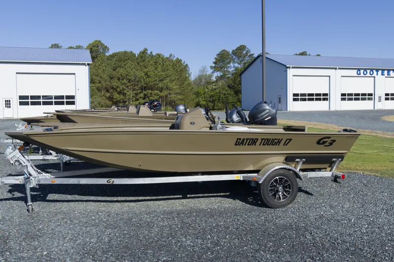 The Image of 2026 G3 Gator Tough 17 SC boat on trailer outside dealership. - 1