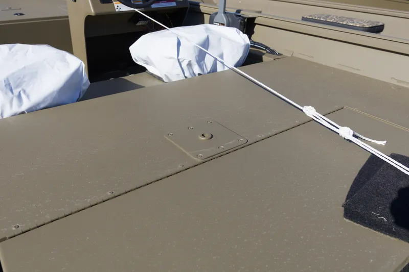 Slide: The Image of 2026 G3 Gator Tough 17 SC boat interior with covered seats and secured rope. - 10