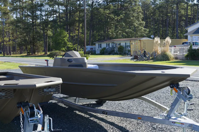 Slide: The Image of 2026 G3 Gator Tough 17 SC boat on trailer, parked outdoors near trees and houses. - 5