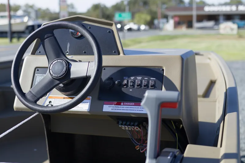 Slide: The Image of Steering console of 2026 G3 Gator Tough 17 SC boat, featuring control panel and steering wheel. - 6