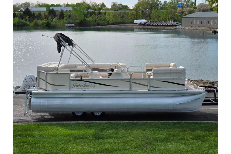 The Image of 2007 Sweetwater Tuscany 2086 RE pontoon boat by a serene lake. - 0