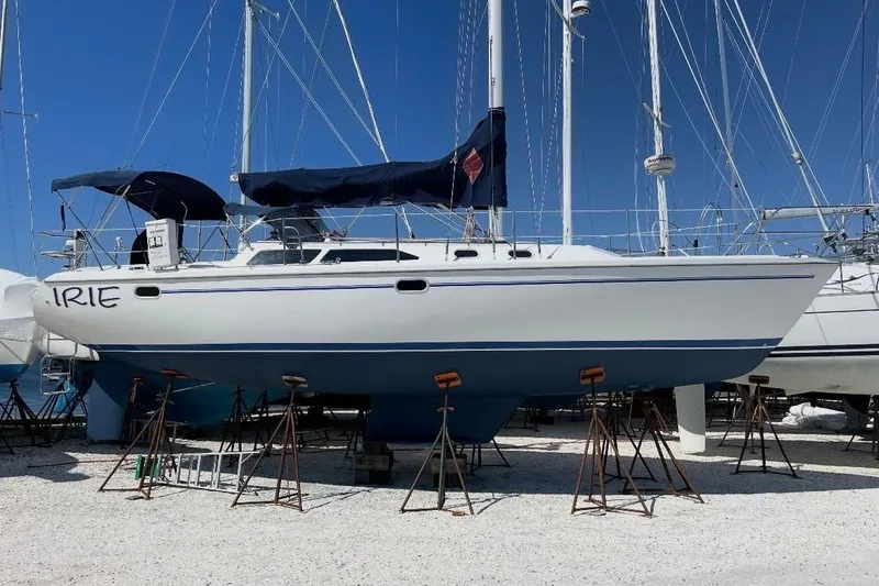 The Image of 2001 Catalina 36 MkII sailboat on stands, with blue accents and covered cockpit. - 0