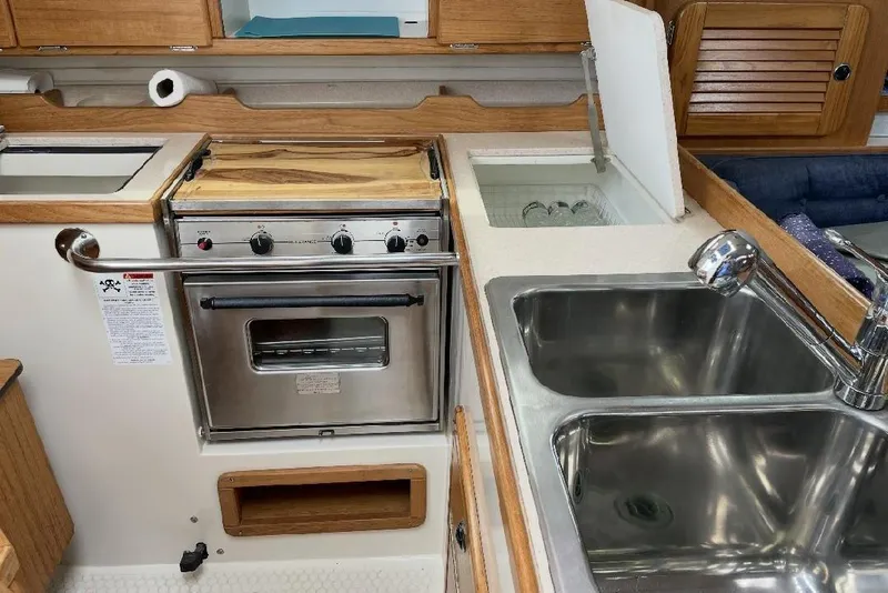 Slide: The Image of Galley kitchen in 2001 Catalina 36 MkII sailboat with stove, sink, and storage. - 12