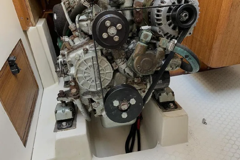 Slide: The Image of Engine compartment of a 2001 Catalina 36 MkII sailboat, showcasing mechanical components. - 13