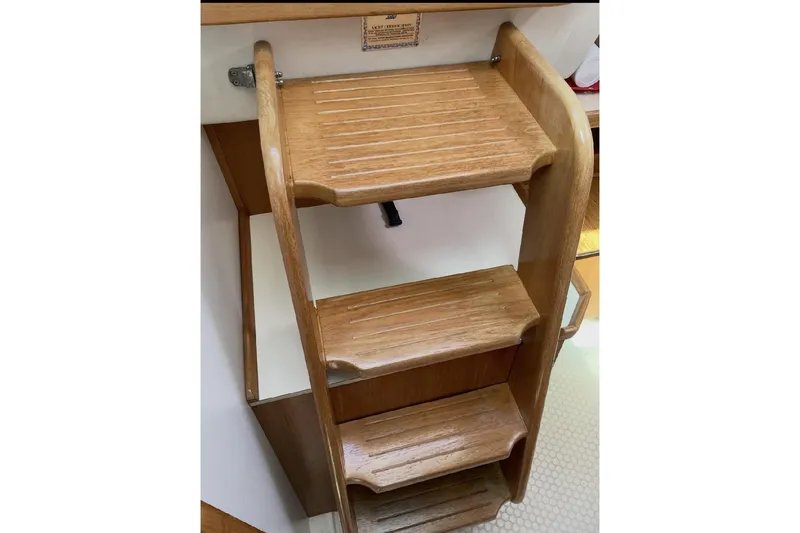 Slide: The Image of Wooden steps inside a 2001 Catalina 36 MkII sailboat, showcasing craftsmanship and design. - 14