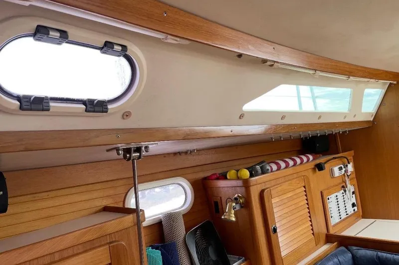 Slide: The Image of Interior of a 2001 Catalina 36 MkII sailboat with wooden cabinetry and portholes. - 16