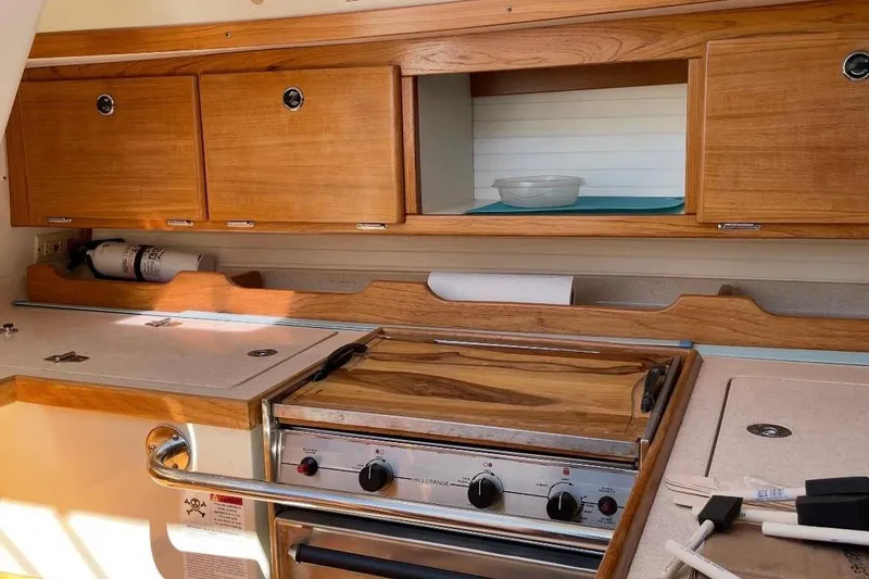 Slide: The Image of Wooden galley kitchen in 2001 Catalina 36 MkII sailboat with stove and storage cabinets. - 17