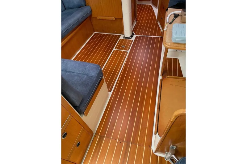 Slide: The Image of Interior of 2001 Catalina 36 MkII sailboat with wooden flooring and blue seating. - 18
