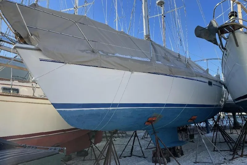 Slide: The Image of 2001 Catalina 36 MkII sailboat on stands, covered, in a boatyard. - 3