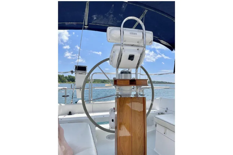 Slide: The Image of Steering wheel of a 2001 Catalina 36 MkII sailboat under a blue sky. - 6