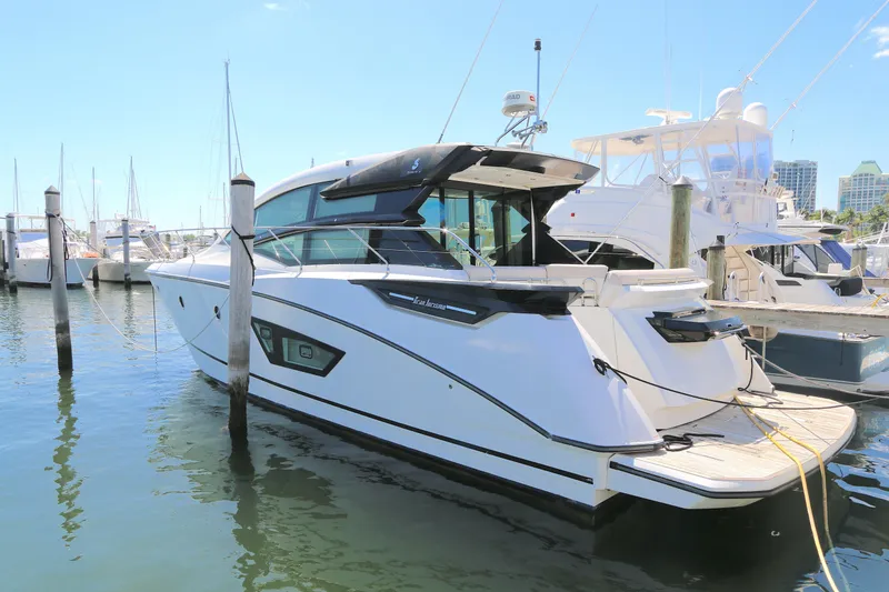 The Image of 2019 Beneteau Gran Turismo 50 yacht docked at marina under clear blue sky. - 0