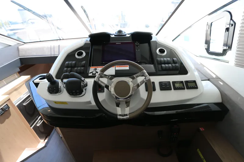 Slide: The Image of 2019 Beneteau Gran Turismo 50 helm with modern controls and sleek design. - 3