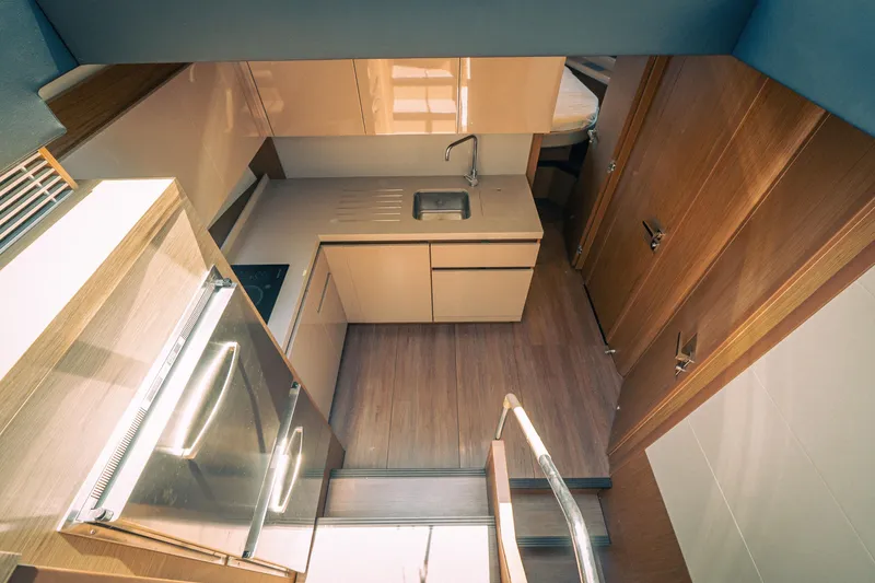 Slide: The Image of Modern kitchen interior of 2019 Beneteau Gran Turismo 50 yacht, featuring sleek cabinetry and appliances. - 4