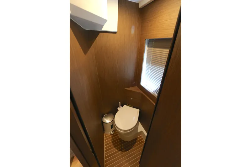 Slide: The Image of Bathroom interior of 2019 Beneteau Gran Turismo 50 yacht, featuring modern design and wooden accents. - 8