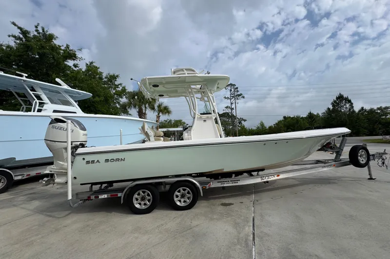 Slide: The Image of 2019 Sea Born FX25 Bay boat on trailer, parked outdoors under cloudy sky. - 10