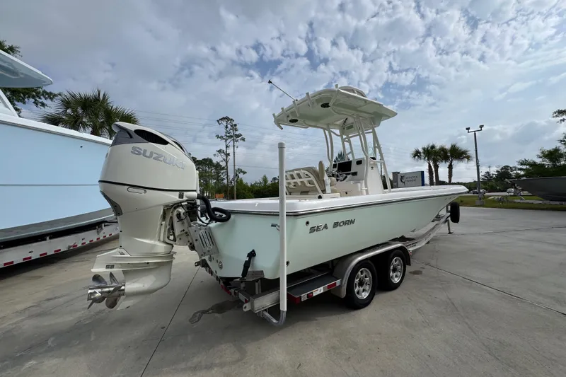 Slide: The Image of 2019 Sea Born FX25 Bay boat on trailer with Suzuki outboard motor. - 12
