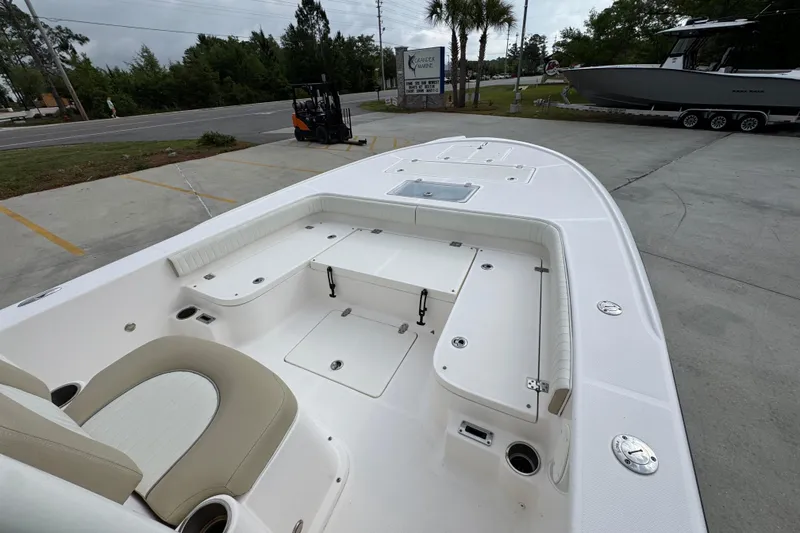 Slide: The Image of 2019 Sea Born FX25 Bay boat with spacious deck and seating, parked outdoors. - 17