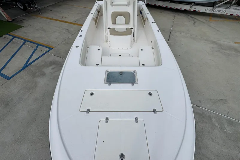 Slide: The Image of 2019 Sea Born FX25 Bay boat deck, featuring storage compartments and seating. - 21