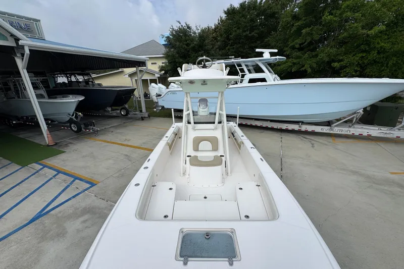 Slide: The Image of 2019 Sea Born FX25 Bay boat in a marina, surrounded by other boats. - 22