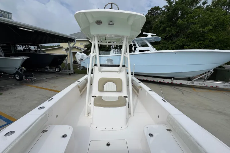 Slide: The Image of 2019 Sea Born FX25 Bay boat in a marina, showcasing sleek design and spacious interior. - 23