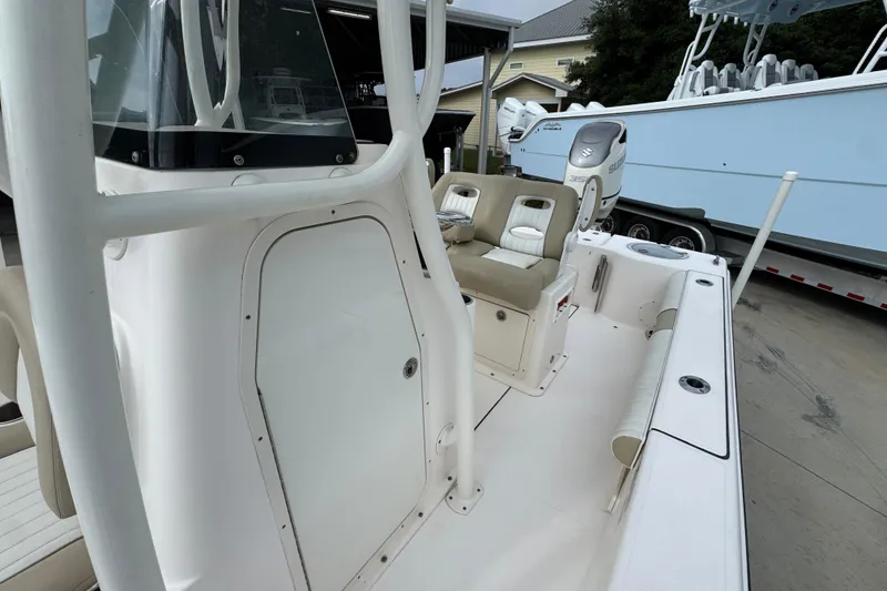 Slide: The Image of 2019 Sea Born FX25 Bay boat interior with seating and console, parked on a trailer. - 25