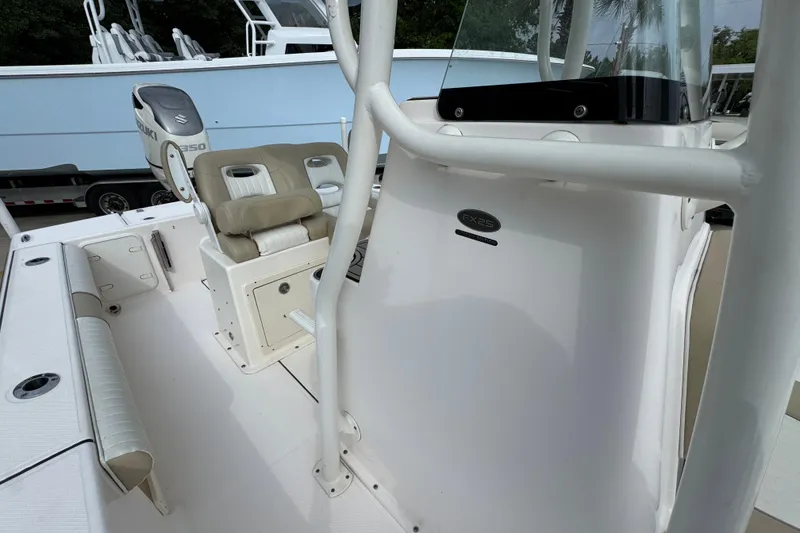 Slide: The Image of 2019 Sea Born FX25 Bay boat interior with seating and console details. - 26