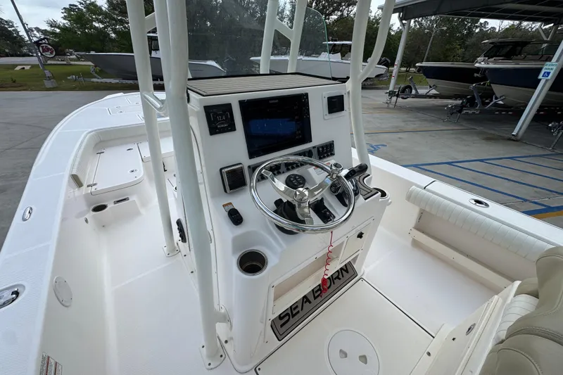 Slide: The Image of 2019 Sea Born FX25 Bay boat interior with steering console and navigation equipment. - 28