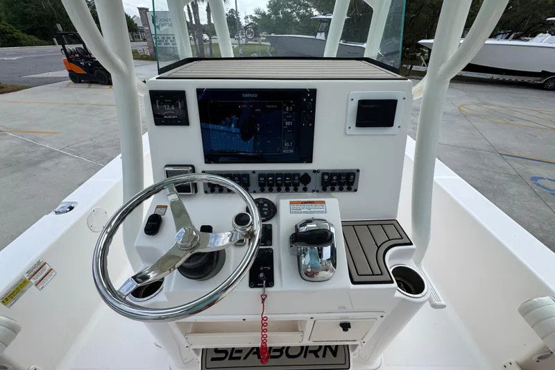 Slide: The Image of 2019 Sea Born FX25 Bay boat console with steering wheel and navigation display. - 29