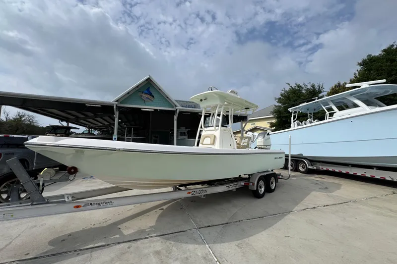 Slide: The Image of 2019 Sea Born FX25 Bay boat on trailer, parked outdoors under cloudy sky. - 3
