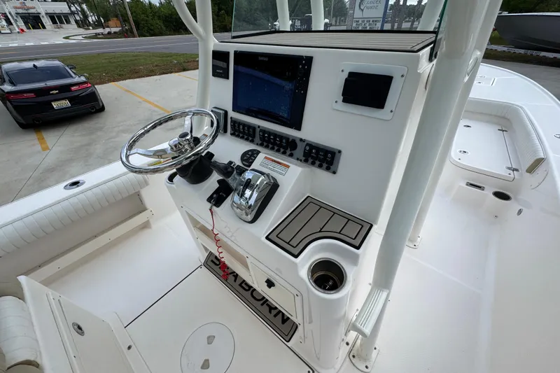 Slide: The Image of 2019 Sea Born FX25 Bay boat console with steering wheel and navigation system. - 30