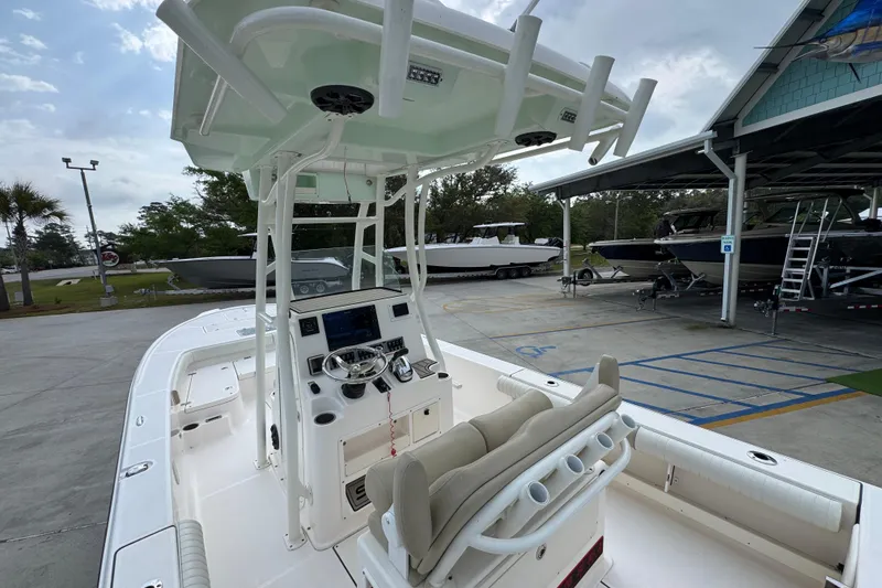 Slide: The Image of 2019 Sea Born FX25 Bay boat with center console and T-top in a marina setting. - 36