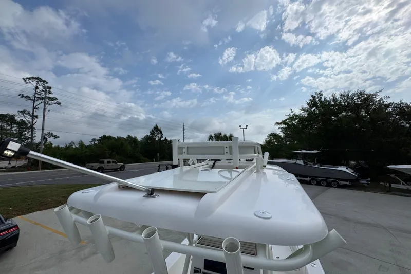 Slide: The Image of 2019 Sea Born FX25 Bay boat roof with rod holders under a cloudy sky. - 38