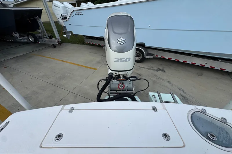 Slide: The Image of 2019 Sea Born FX25 Bay boat with Suzuki 350 outboard motor in a parking area. - 40
