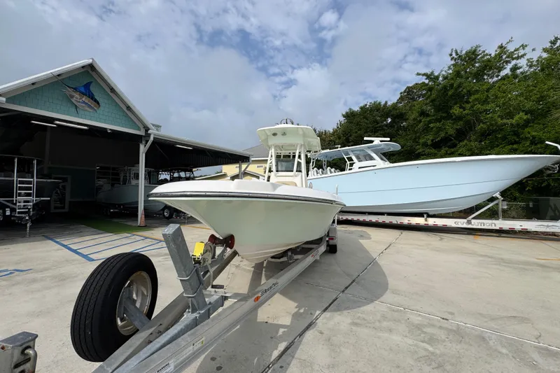 Slide: The Image of 2019 Sea Born FX25 Bay boat on trailer at marina, clear sky background. - 5