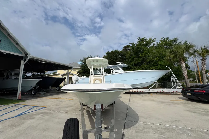 Slide: The Image of 2019 Sea Born FX25 Bay boat on trailer in marina parking lot. - 6