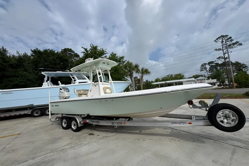 Slide: The Image of 2019 Sea Born FX25 Bay boat on trailer under cloudy sky. - 8