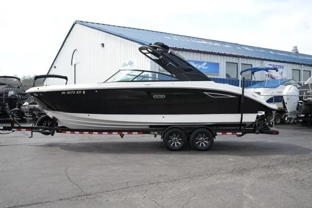 The Image of 2025 Sea Ray SDX 270 boat on trailer, parked outside a dealership. - 1