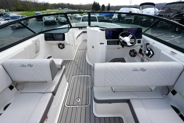 Slide: The Image of 2025 Sea Ray SDX 270 boat interior with luxurious seating and modern dashboard. - 12
