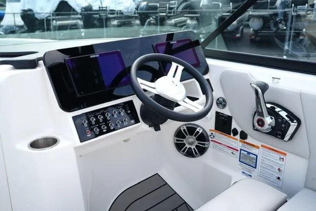 Slide: The Image of 2025 Sea Ray SDX 270 helm with modern controls and sleek dashboard design. - 13