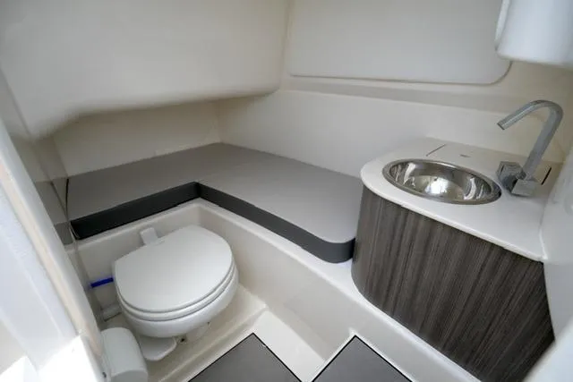 Slide: The Image of 2025 Sea Ray SDX 270 boat interior with toilet and sink. - 15