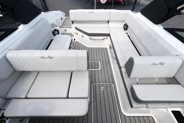 Slide: The Image of 2025 Sea Ray SDX 270 boat interior with luxurious white seating and sleek design. - 16
