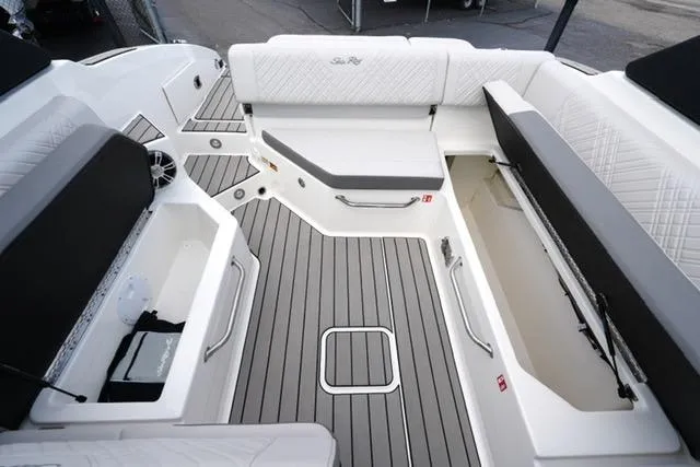 Slide: The Image of 2025 Sea Ray SDX 270 boat interior with spacious seating and storage compartments. - 17