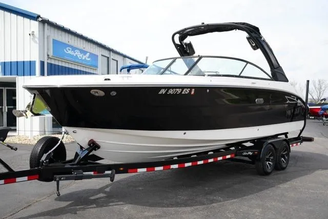 Slide: The Image of 2025 Sea Ray SDX 270 boat on trailer, parked outside dealership. - 2