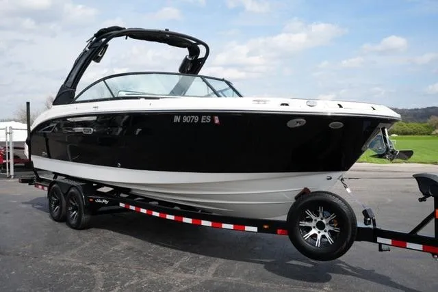 Slide: The Image of 2025 Sea Ray SDX 270 boat on trailer, black and white design, parked outdoors. - 3