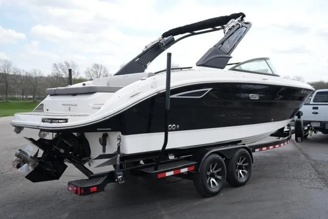 Slide: The Image of 2025 Sea Ray SDX 270 boat on trailer, sleek black and white design, parked outdoors. - 5