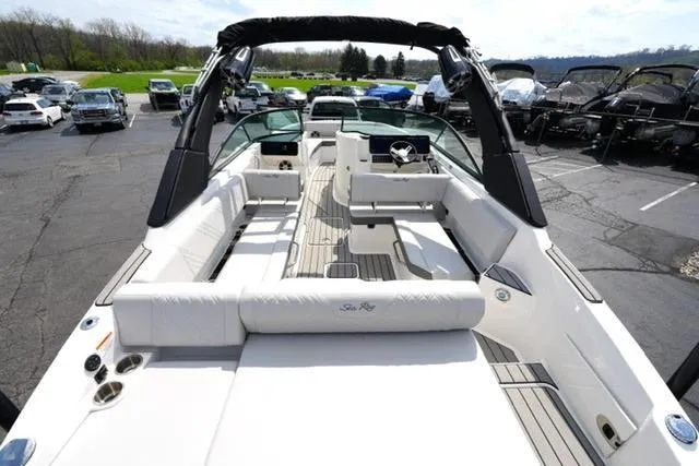 Slide: The Image of 2025 Sea Ray SDX 270 boat with spacious seating and sleek design in a marina setting. - 8