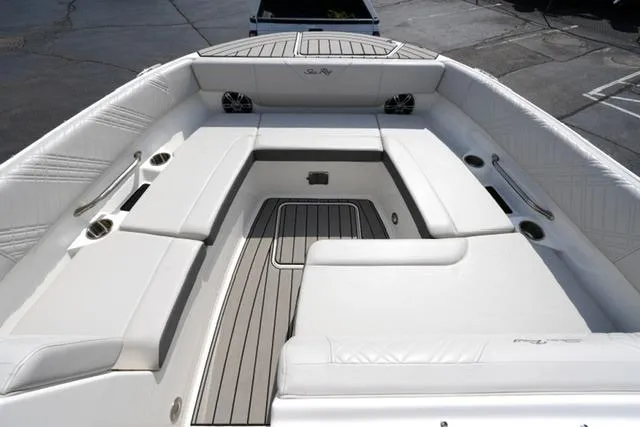 Slide: The Image of 2025 Sea Ray SDX 270 boat interior with white seating and wood flooring. - 9