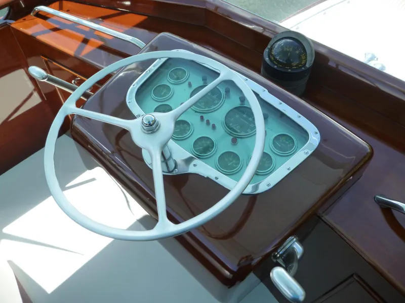 Slide: The Image of 1949 Rybovich Sport Fish boat helm with vintage steering wheel and gauges. - 10