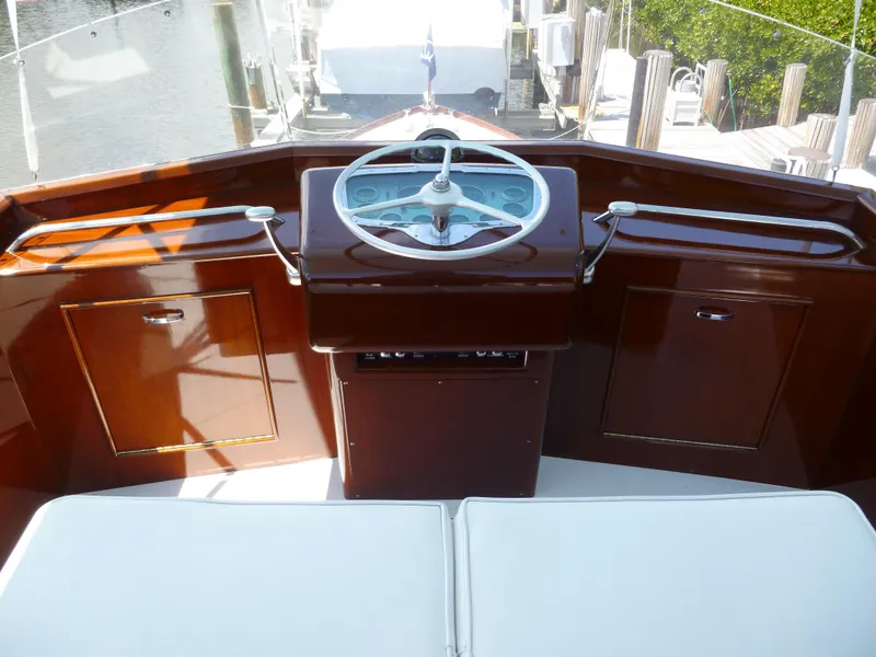 Slide: The Image of 1949 Rybovich Sport Fish boat helm with wooden finish and classic steering wheel. - 11