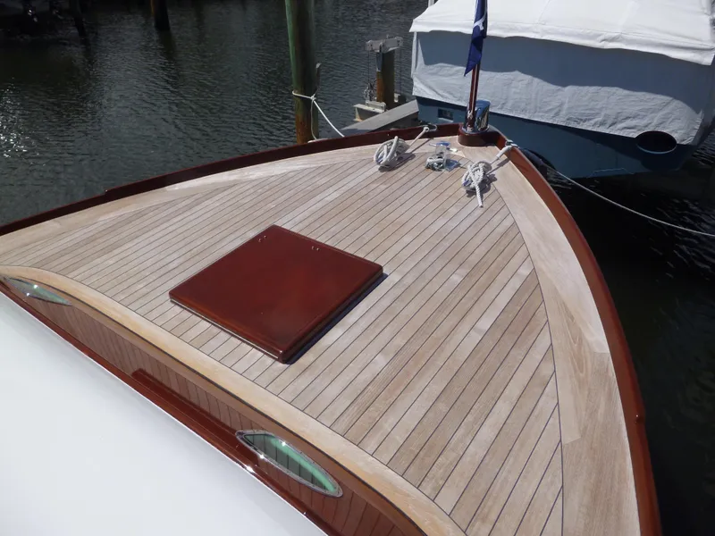 Slide: The Image of 1949 Rybovich Sport Fish boat with wooden deck, docked in marina. - 16